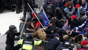 Pro-Trump protesters tear down a barricade as they clash with Capitol Police